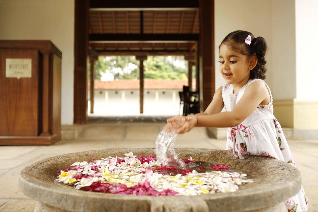 Heritage Мадурай Экстерьер фото A girl playing with flowers
